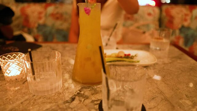 Elegant Cocktail Pour in Cozy Restaurant Setting