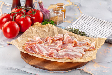 Sliced pork bacon over board