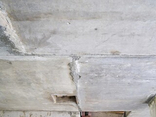 A weathered concrete ceiling is captured, displaying various textures and architectural elements.