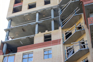 The raw essence of a building site: an unfinished structure of bricks, concrete, and scaffolding.