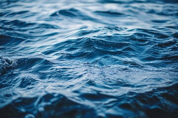 Serene ocean waves gracefully rolling across a soothing deep blue water surface under bright skies