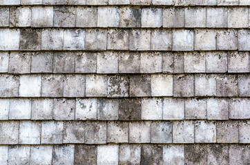 Brown stone wall from square parts, old concrete texture lined up square sheet. Surface background.