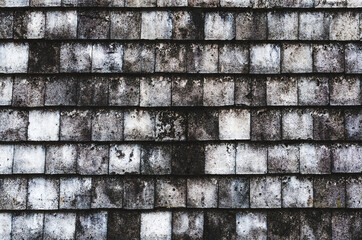 black and white stone wall from square parts, old concrete texture lined up square sheet. Surface background.