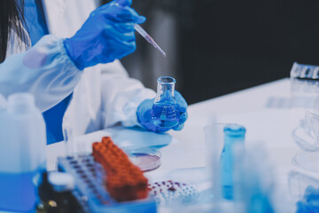 Fototapeta premium Research, experiment and medical trial being done by a scientist in a lab, science facility or hospital. One young, serious and professional researcher organizing, sorting or making a discovery