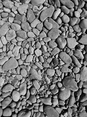 Grey darker pebbles stone for background., backdrop