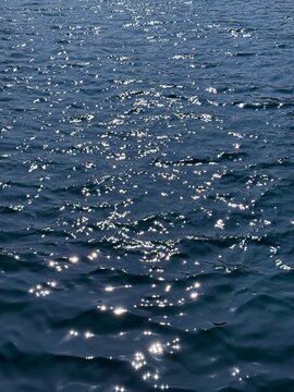 Sea blue twinkling waves surface.