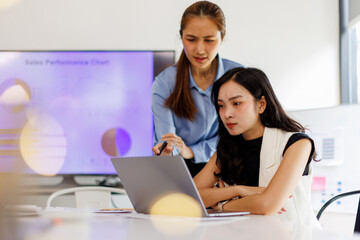  Two business woman lawyer or company employee holding accounting bookkeeping documents checking financial data or marketing report working in office with laptop. Paperwork management
