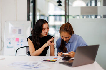 Two asian business woman Accounting using calculating income-expenditure and analyzing real estate investment data report Financial and tax systems concept.	