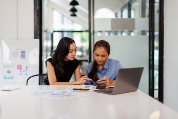 Two asian business woman Accounting using calculating income-expenditure and analyzing real estate investment data report Financial and tax systems concept.	