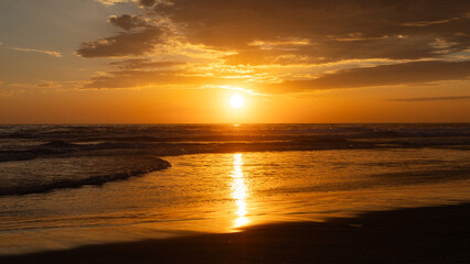 Sun setting over the Pacific Ocean from Mission Beach in San Diego, California, USA taken on June...