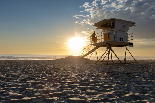 Sun setting over the Pacific Ocean from public lifeguard tower 13 at Mission Beach in San Diego, California, USA taken on June 1, 2025