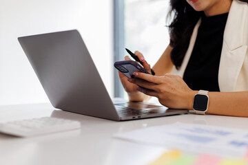 Laptop, Phone, hand and business woman with cellphone in office for online email communication for corporate review. Technology and hr with computer and phone for reading company policy on internet,
