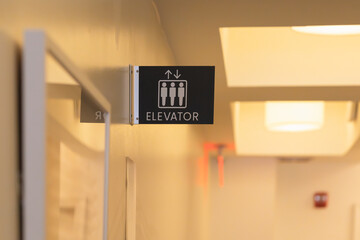 Elevator sign in a well-lit hallway