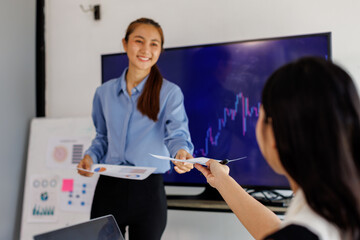 Employees, computer finance, stock market and graphs on screen for data analytics. Asian Business people, collaboration and teamwork or support, training and statistics on investment revenue
