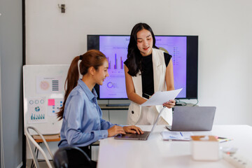 Business teamwork and meeting for strategy, planning or corporate brainstorming discussion at office. Asian Business people meeting explaining the financial graph data and marketing plan.
