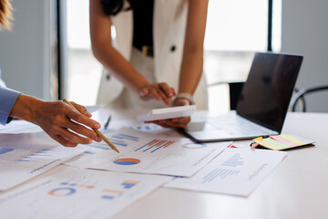 Financial analysts analyze business financial reports on a digital tablet planning investment...