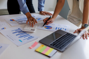 Financial analysts analyze business financial reports on a digital tablet planning investment...