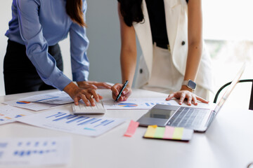 Financial analysts analyze business financial reports on a digital tablet planning investment...