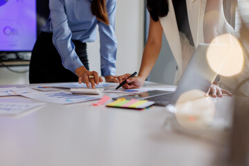 Financial analysts analyze business financial reports on a digital tablet planning investment...