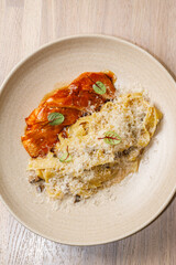 Delicious pasta dish with succulent meat and cheese served in a stylish restaurant