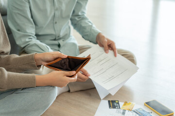 Stressed and headache asian couple with large bills or invoices no money to pay to expenses and credit card debt. shortage, Financial problems, mortgage, loan, bankruptcy, bankrupt, poor, empty wallet