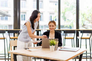 Finance and investment concept. Two Business asian women analyzing market data, financial graph report, economic growth, business strategy, planning and solution, risk management
