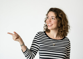 Happy Young Woman Pointing to the Side – Studio Portrait with Striped Top, Tattoo Detail, White Background, High-Resolution Stock Photo with Copy Space for Advertising and Marketing