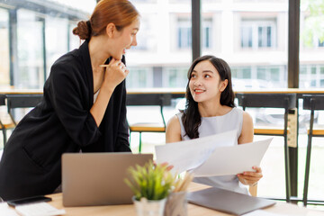 Two professional caucasian asian business women friends collaboration, working together at office, using laptop, Generally accepted audit standards, Earnings before interest and taxes
