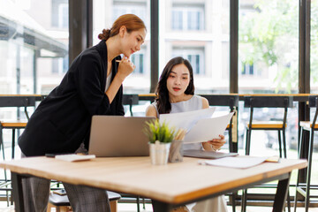 Two professional caucasian asian business women friends collaboration, working together at office, using laptop, Generally accepted audit standards, Earnings before interest and taxes
