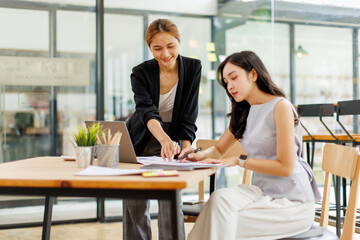 Two professional caucasian asian business women friends collaboration, working together at office, using laptop, Generally accepted audit standards, Earnings before interest and taxes
