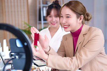 Asian Women Demonstrating Lipstick in Beauty Tutorial Video with Ring Light and Makeup Palette for Online Cosmetics Brand Promotion