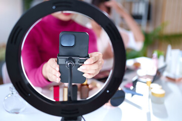 Asian Young Women Hands Hold Phone for Makeup and Beauty Video Tutorial with Ring Light at Home...