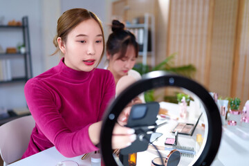 Asian Women Beauty Blogger Live Streaming Makeup Tutorial Using Ring Light and Smartphone for Beauty Tips and Tricks Online Content Creation and Social Media Marketing
