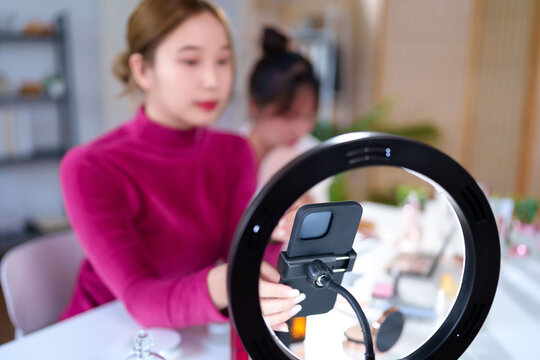 Asian Women with Ring Light for Beauty Vlogging Live Stream and Mobile Phone for Social Media Content Creation