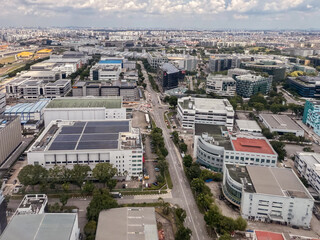 Aerial view of urban landscape with buildings and roads in Singapore during flight approach