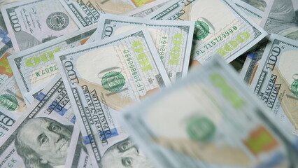 A large pile of U.S. Hundred Dollar Bills, representing cash and the concept of wealth in finance