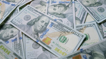 Stacks of Hundred Dollar Bills Are Placed Out and Spread Across the Surface for Display