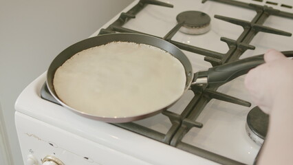 Cooking Delicious Crepes on a Gas Stove Using a Spatula for an Exquisite Meal Experience