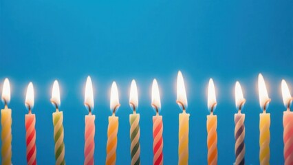 Colorful birthday candles burning in a row, celebrating joy and warmth
