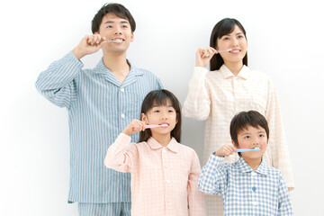 パジャマ姿で歯磨きをする家族