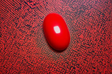 Red Capsule on Abstract Patterned Surface. Generative AI.