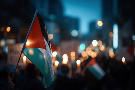 Palestine flag waving gently in the wind, peaceful protest atmosphere, soft lighting, people in the background holding candles and signs of peace, blue and white tones, unity AI Generated - Powered by Adobe