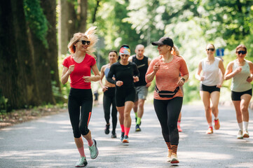 Obraz premium Activity, healthcare conception. Group of runners are together outdoors