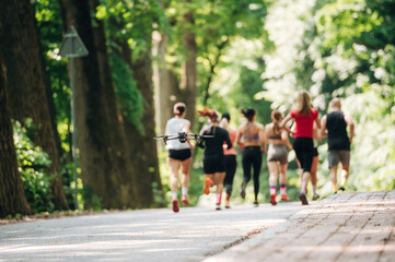 Obraz premium Adults are running together. Group of people are outdoors