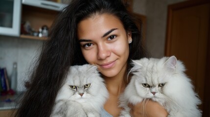 Naklejka na ściany i meble Young hispanic female smiling with two fluffy white cats indoors. International Childfree Day