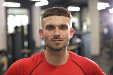 Portrait of professional personal trainer in gym