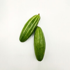 Potol or pointed gourd vegetable on isolated white background. Pointed gourds over white...