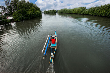Wooden boat crossing the big river