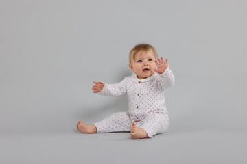 Cute little baby on light grey background