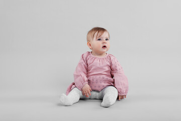Cute little baby on light grey background